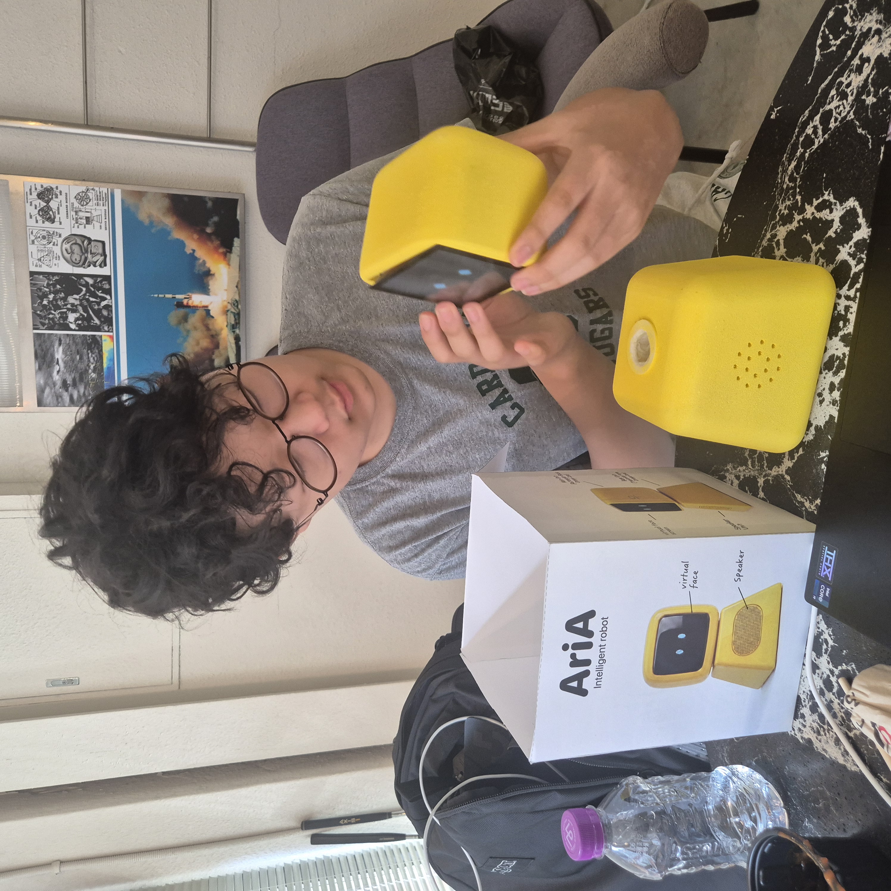 Me assembling the yellow AriA companion robot